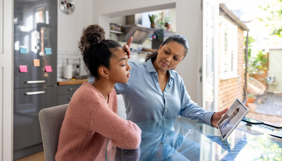 Mother with sick daughter on video call with doctor