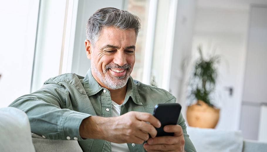 Man smiling looking at his cell phone