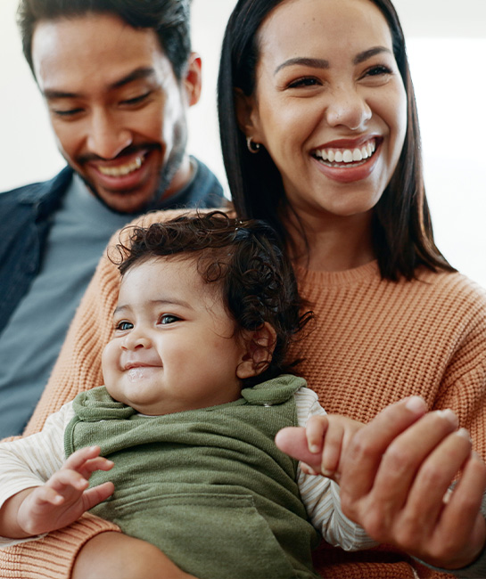 multi-generational family with baby smiling and happy