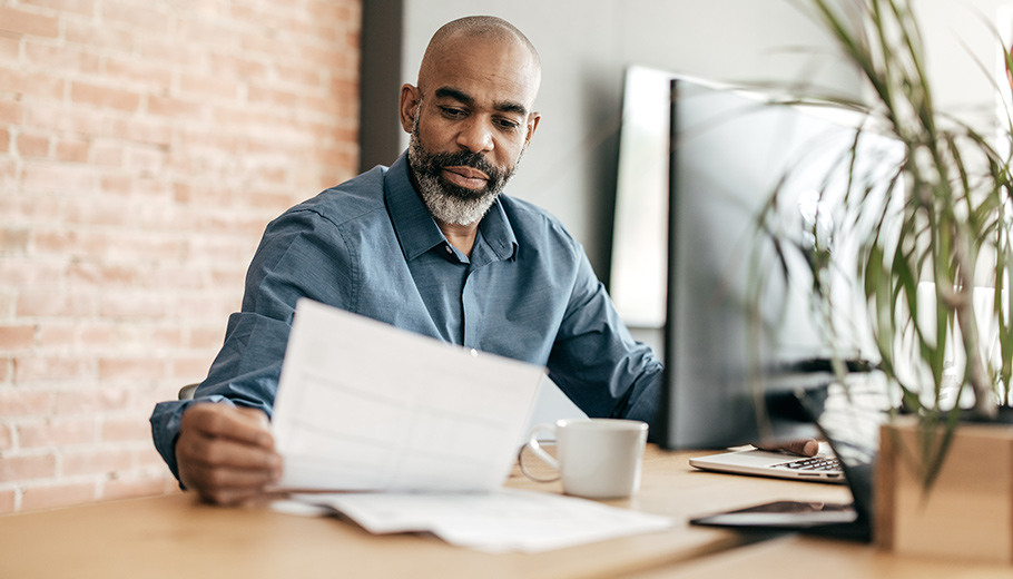 Man reviewing a letter looking concerned