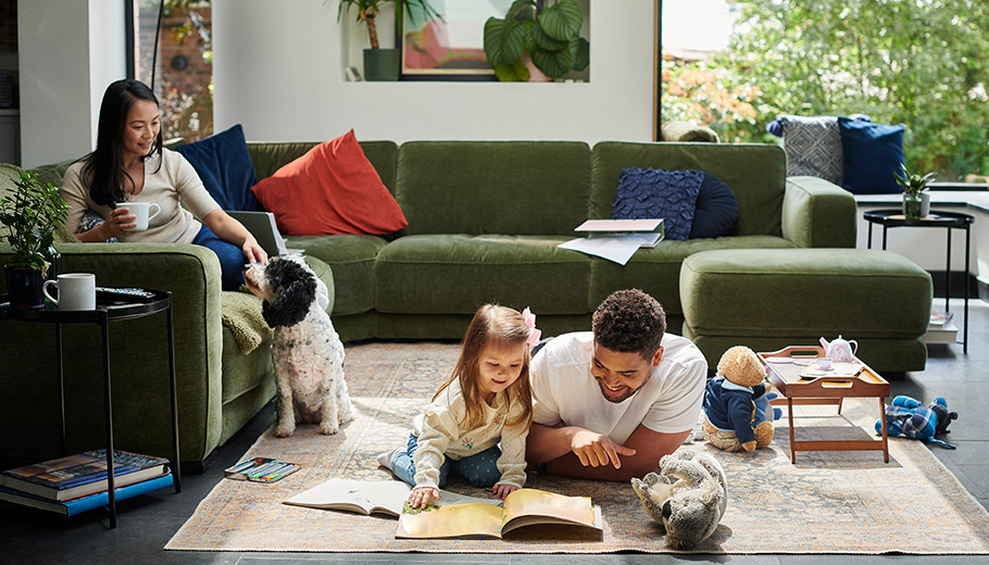 Family hanging out in living room with their dog