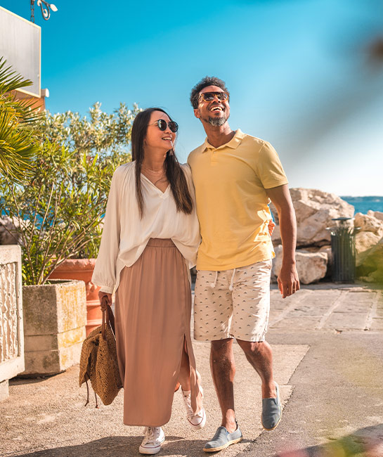 Couple holding hands in a beach town on vacation 