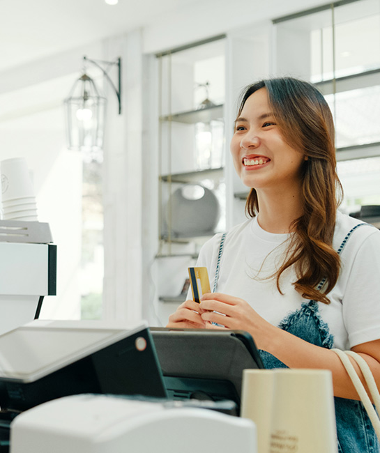 Woman paking contactless payment with credit card