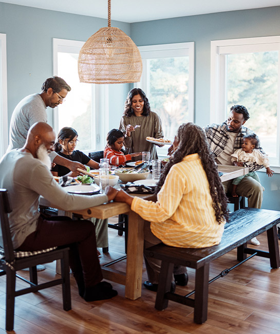 Large family ghaving dinner at the table